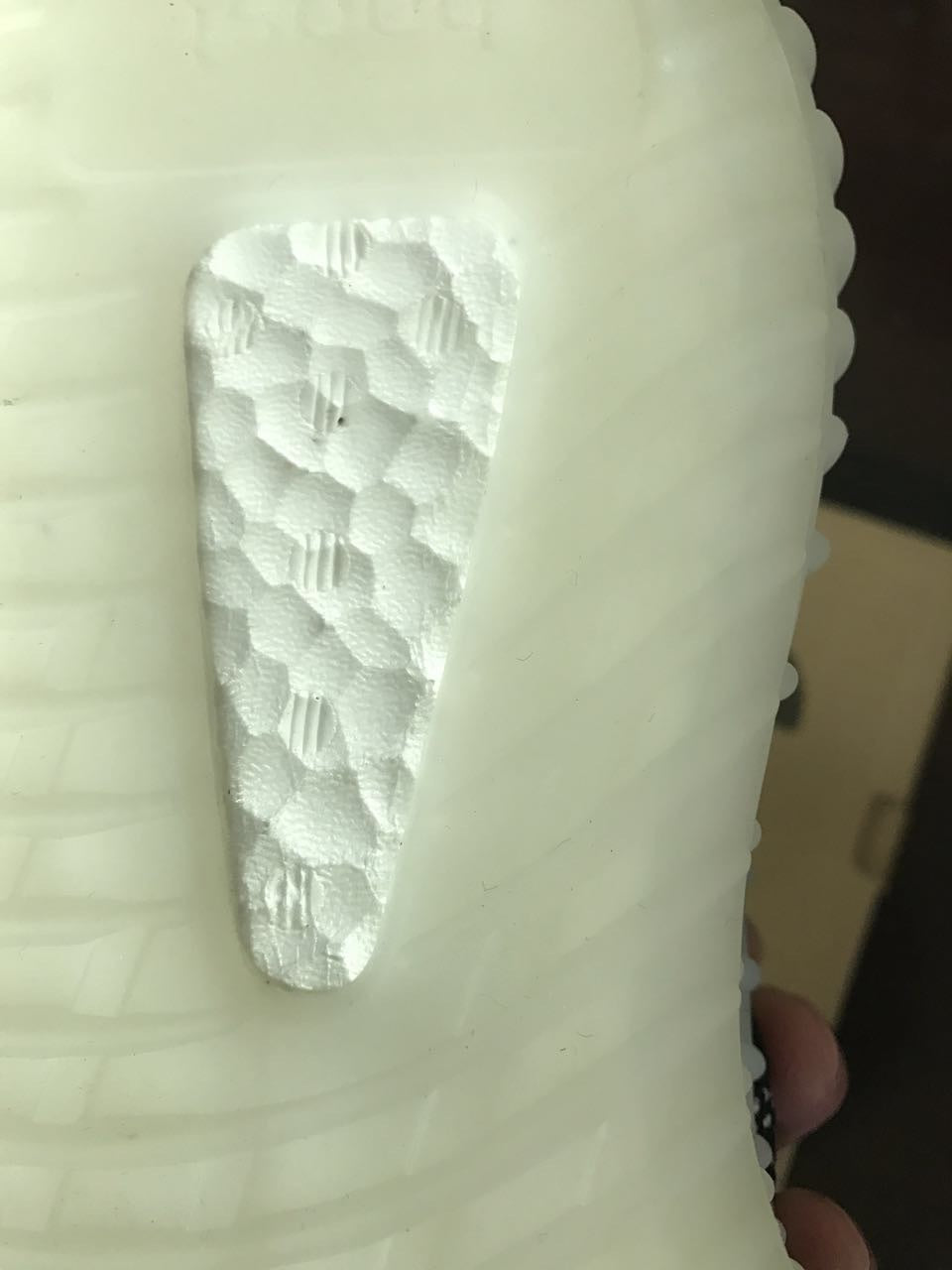 Yeezy 350 V2 Glow-in-the-Dark Sneakers, in Black and White - product image from the listing.