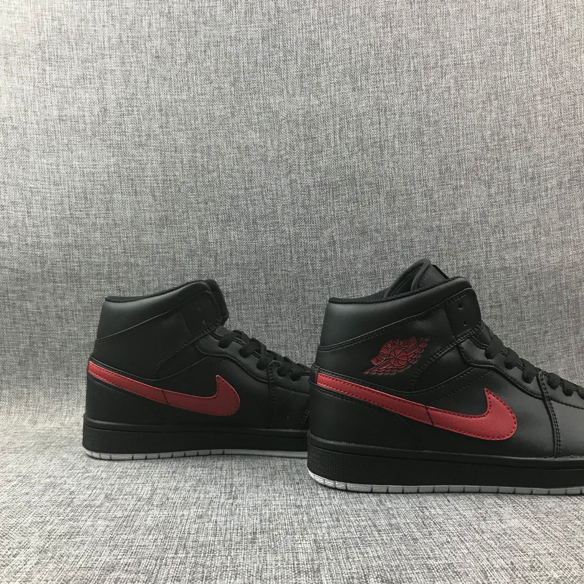 Air Jordan 1 Mid Sneakers in Black and Red 554724-045 - product image from the listing.