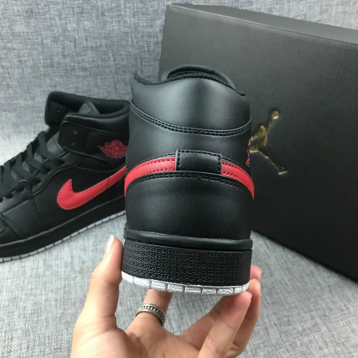 Air Jordan 1 Mid Sneakers in Black and Red 554724-045 - product image from the listing.