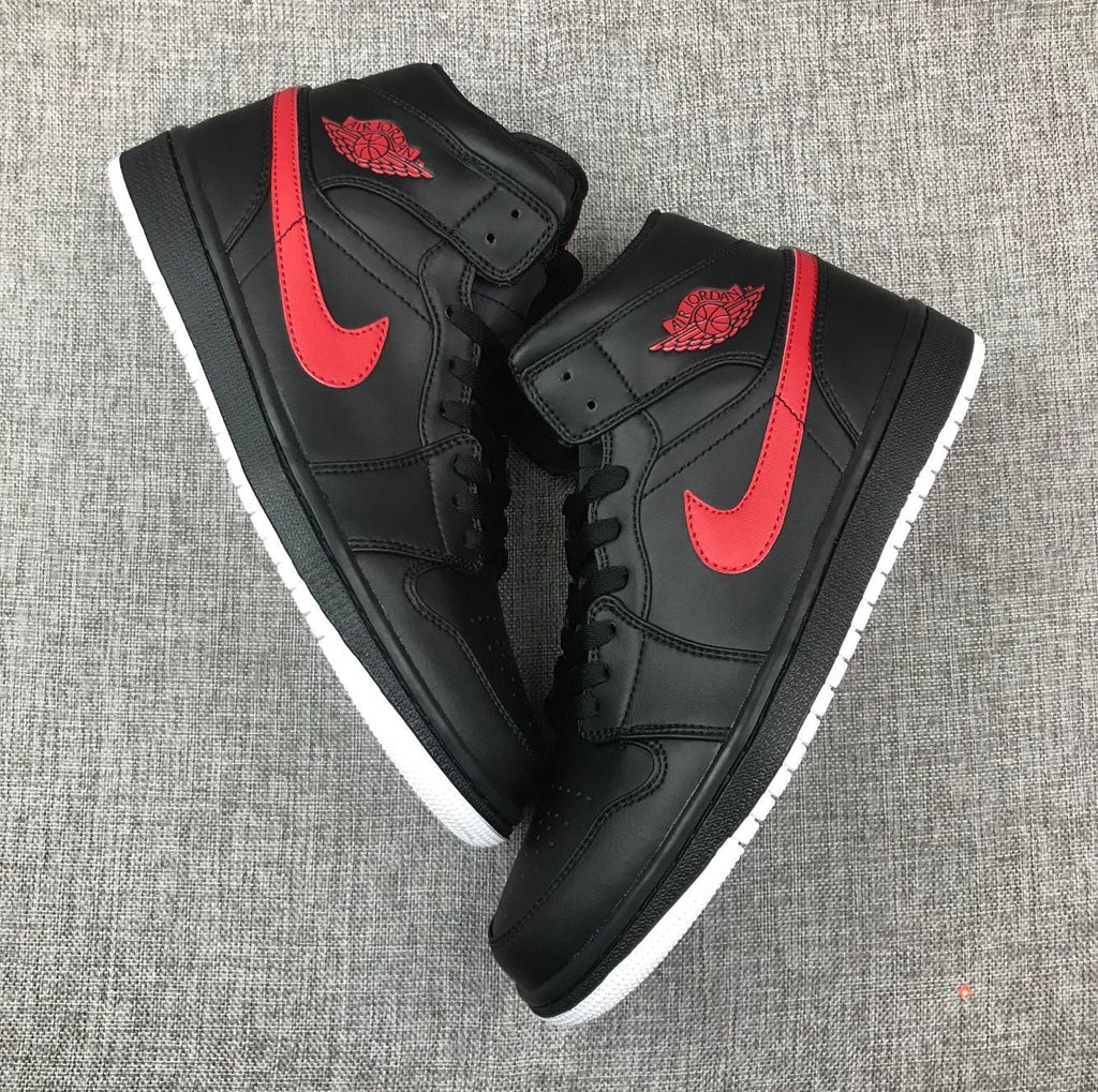 Air Jordan 1 Mid Sneakers in Black and Red 554724-045 - product image from the listing.