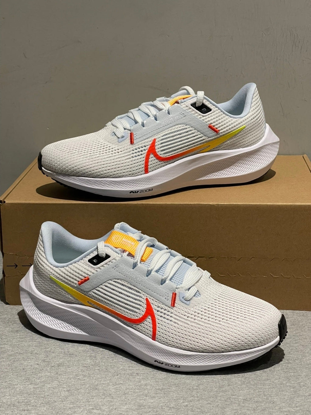 Nike Air Zoom Pegasus 40 Running Shoes in White Blue Orange DV3854-102 - product image from the listing.